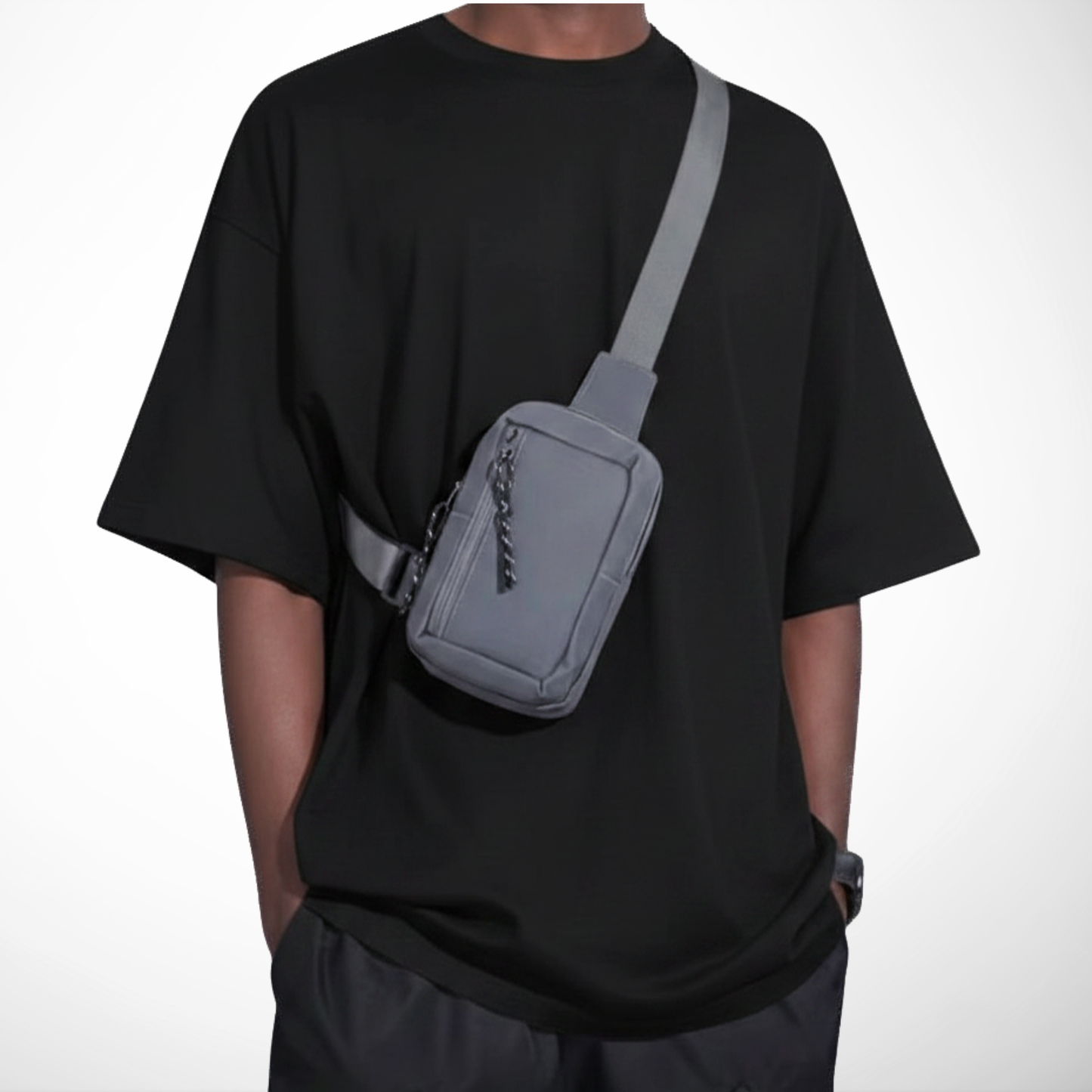 Person wearing a gray crossbody bag on a white background