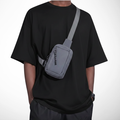 Person wearing a gray crossbody bag on a white background
