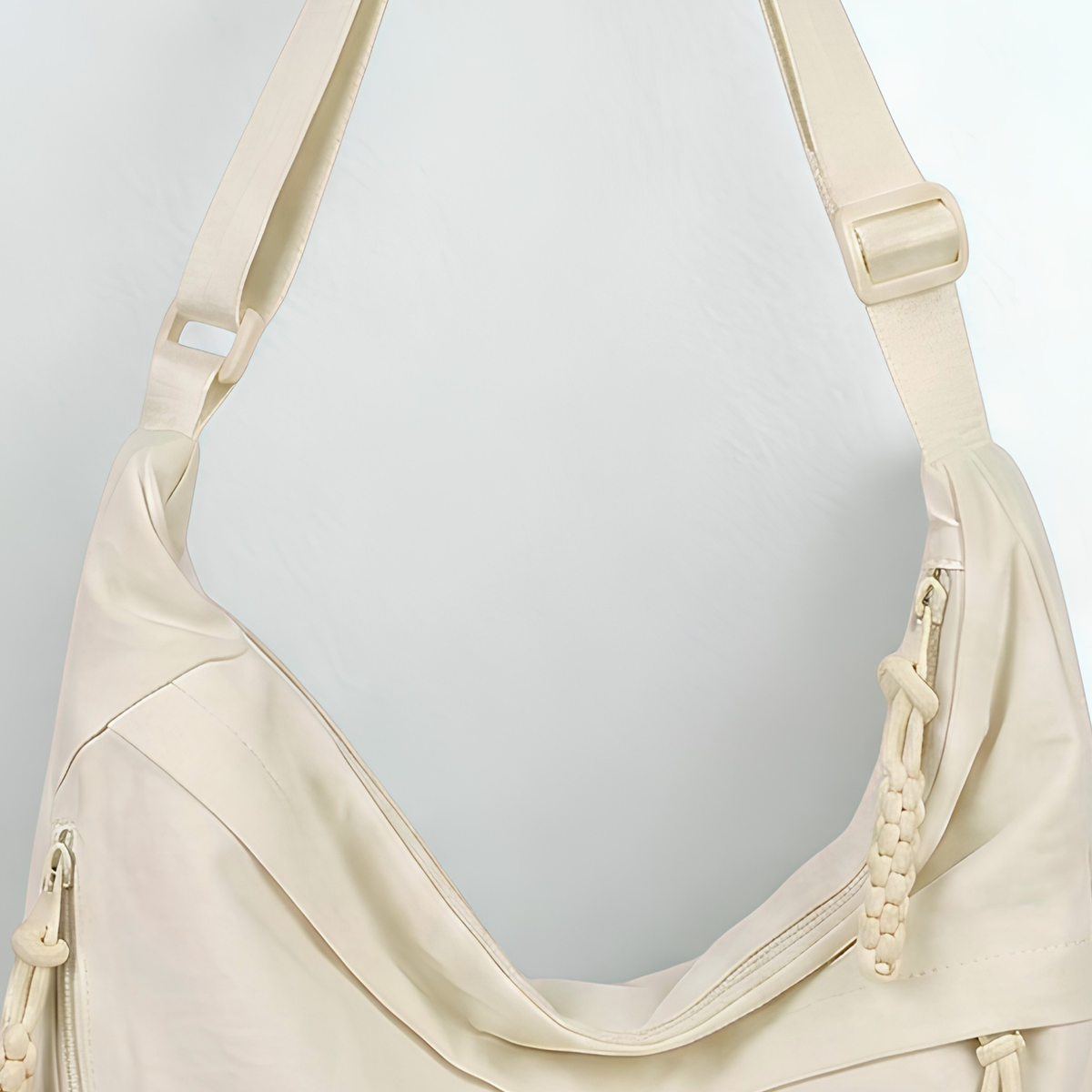 Beige handbag with a strap on a light gray background