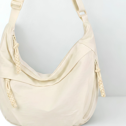Beige handbag with a strap on a light gray background