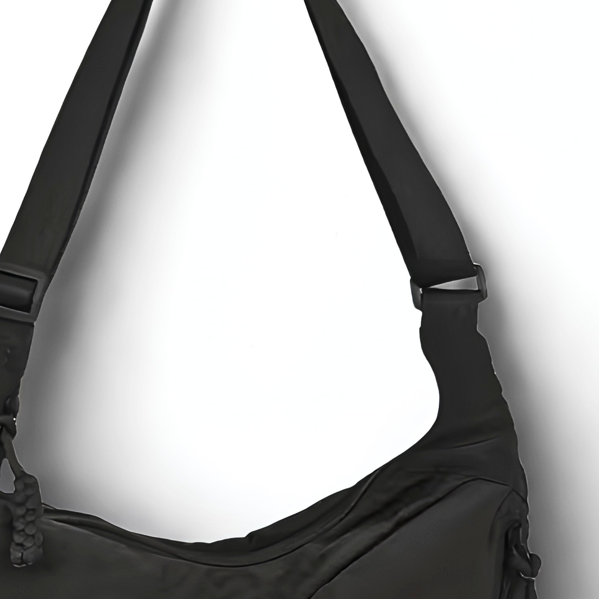 Black shoulder bag with a strap on a white background