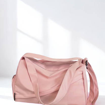 Pink duffel bag with white background