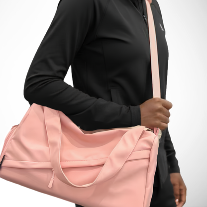 pink duffel bag on girls shoulder on the way to the gym
