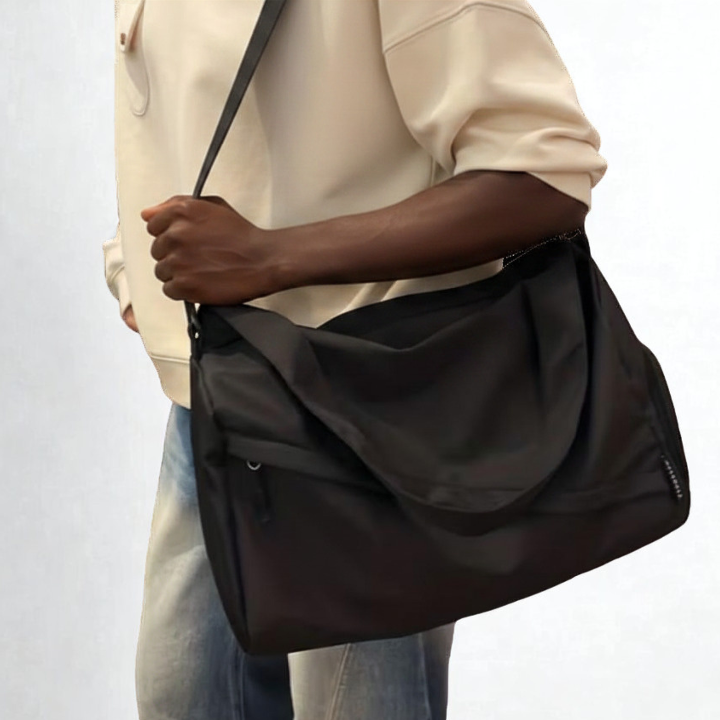 Guy holding a black duffel bag on his way somewhere